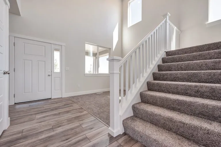 Front door and stairs in a new home from McArthur Homes.