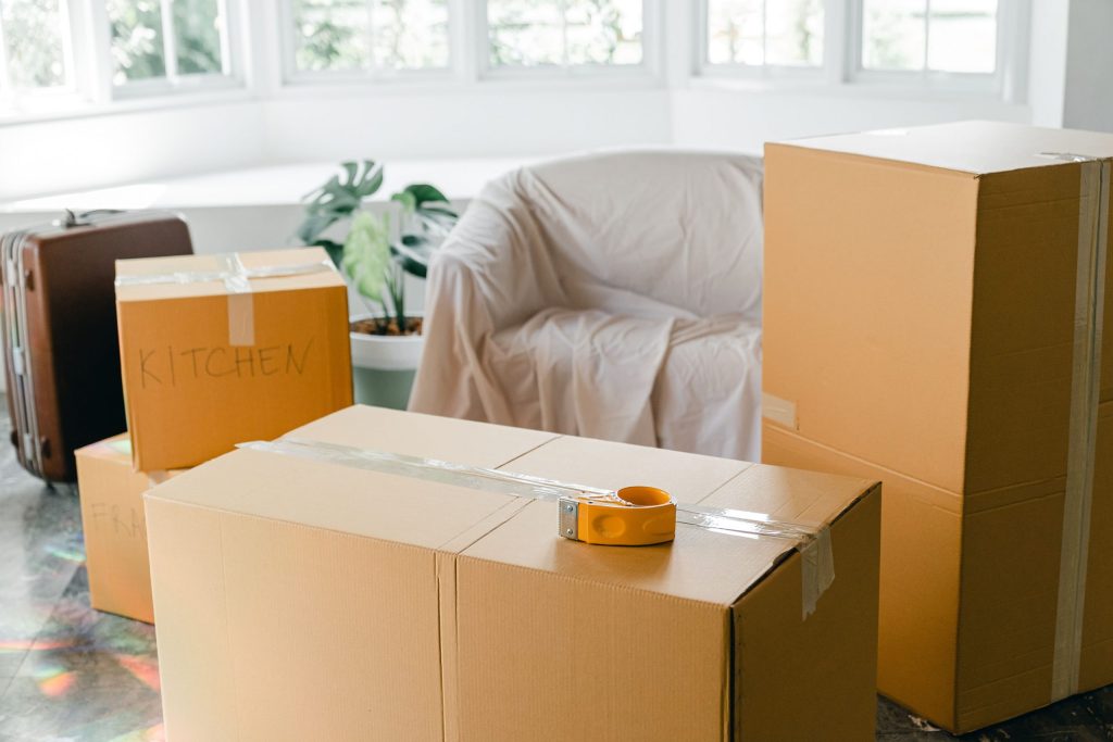 Boxing Stacked Up With Tape And Labeled for Different Rooms