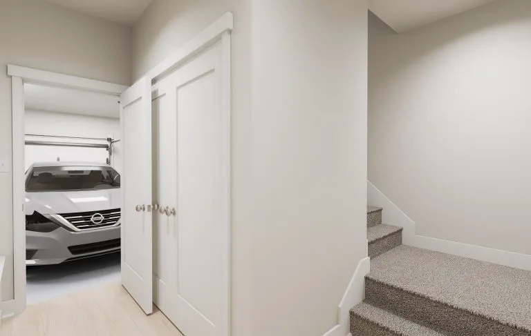 A modern hallway with beige walls and carpeted stairs. A closet with sliding doors is open, revealing a silver car parked in an attached garage—typical of many well-designed homes in Utah.