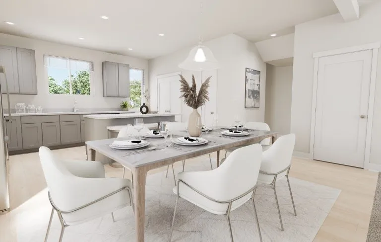 Modern dining area with a light wooden table set for six, white cushioned chairs, a neutral vase with dried plants as centerpiece, and an open kitchen in the background—capturing the stylish comfort of homes in Utah.