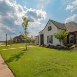 Street view of a McArthur Homes community featuring new single-family homes and townhomes in Utah.